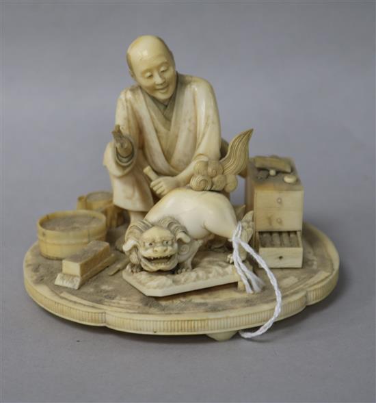A Japanese Meiji carved ivory group of a wood carver (a.f.)